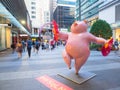Cute pink pig sculpture with funny posture to celebrate year of the pig at World square building.
